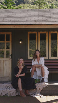 Video of models wearing handmade linen dresses in midi length and v-neckline. Dresses in black and white linen