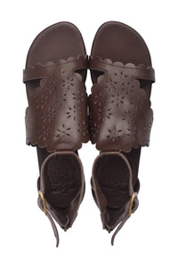 A pair of dark brown leather sandals with laser-cut floral patterns and scalloped edges, shown from a top-down view on a white background.