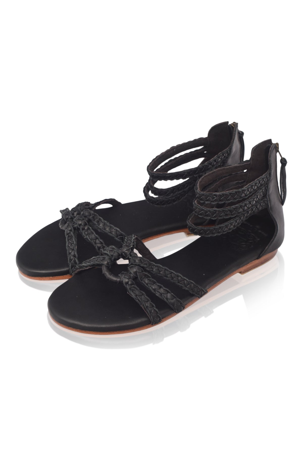 Black braided leather sandals with ankle straps on a white background — handmade by Bali ELF