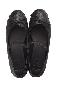 A pair of black woven leather ballet flats with braided straps, shown from a top-down view on a white background.