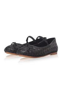 A pair of black woven leather ballet flats with braided ankle straps and small bow details, displayed on a clean white background with a soft reflection.
