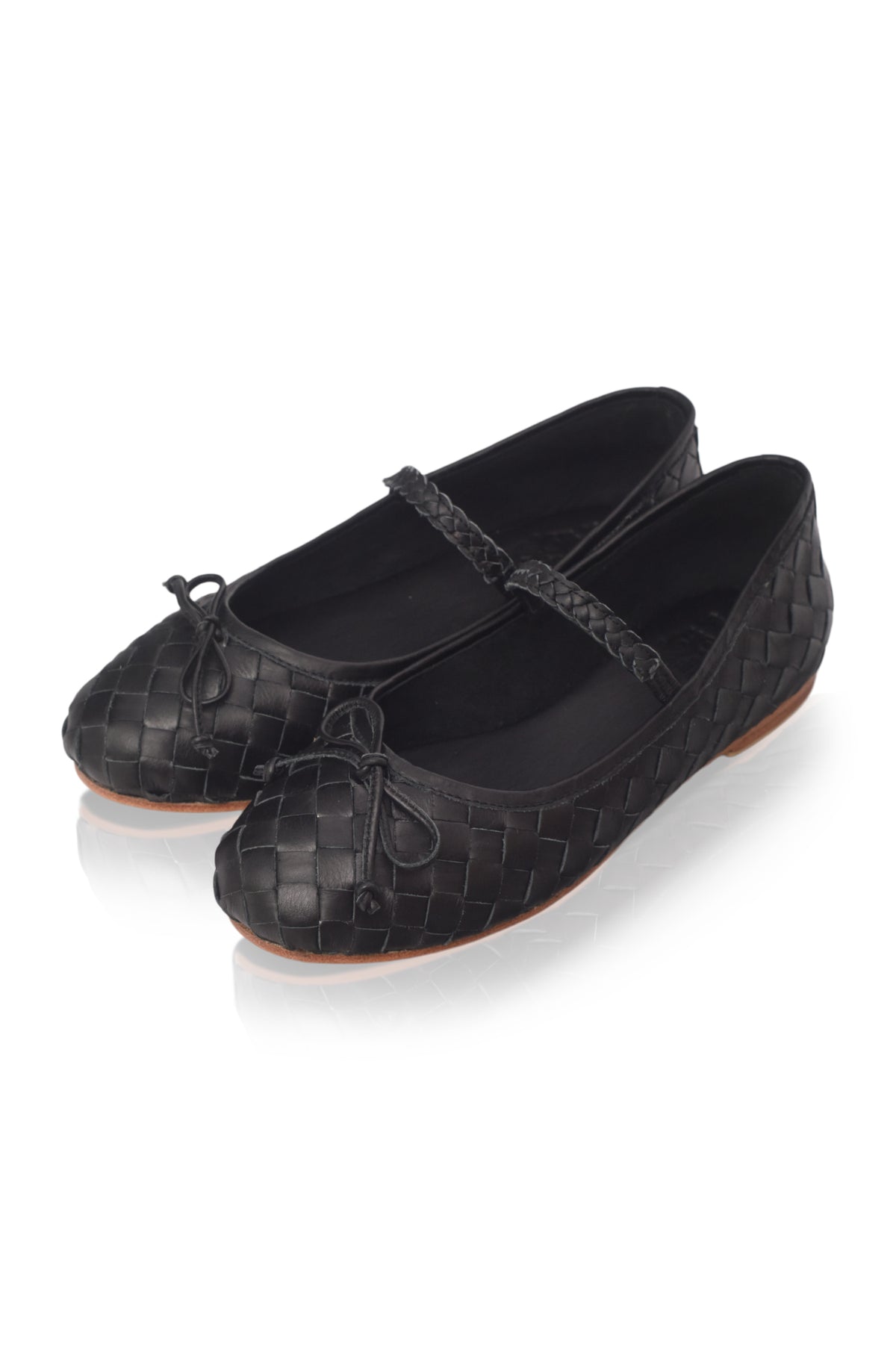A pair of black woven leather ballet flats with Mary Jane straps and small bow details on the toes, displayed on a clean white background with a soft reflection.
