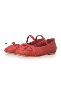 Brown ballerina shoe with a strap on a white background