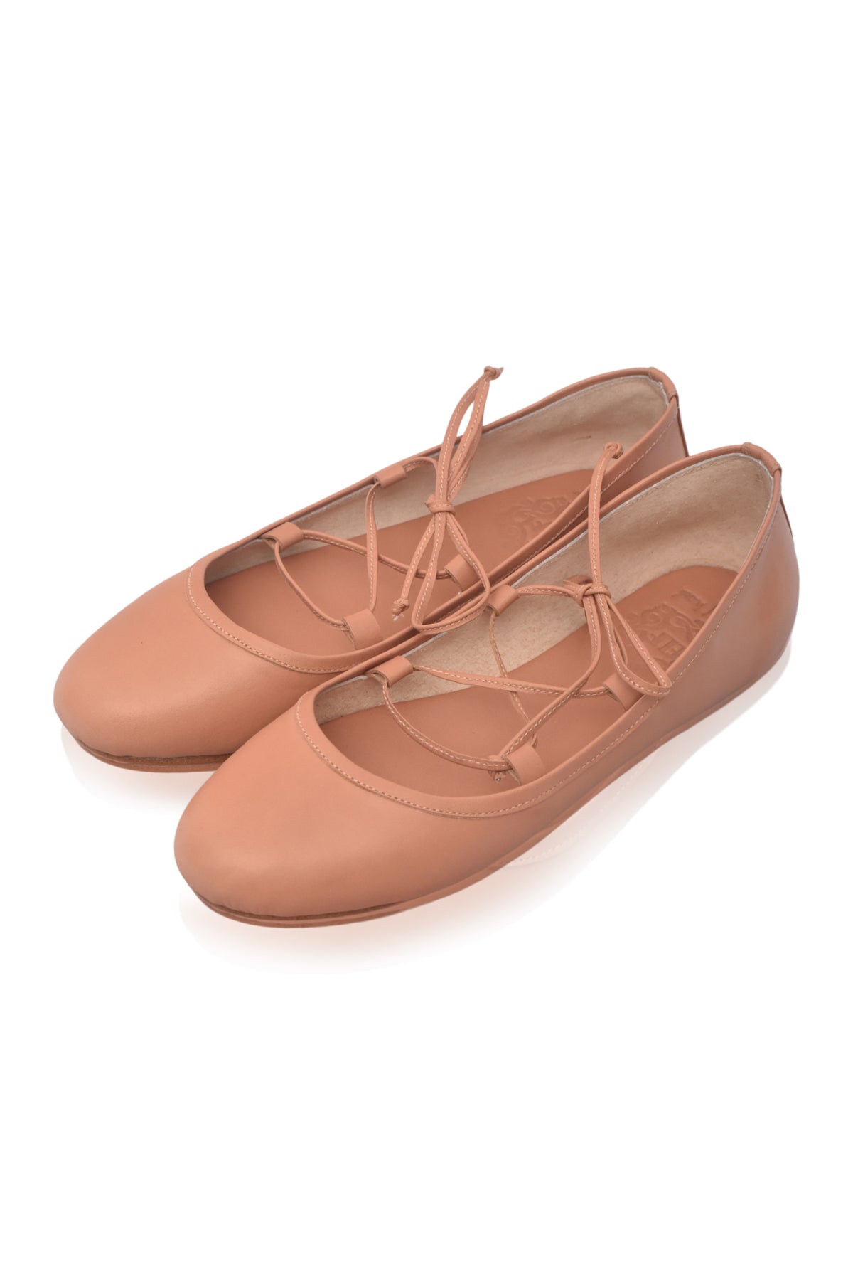 A pair of dusty rose ballet flats with lace-up front straps, shown on a clean white background.
