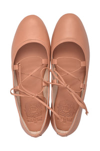 A pair of ballet flats in a warm nude tan color, featuring lace-up front straps and a low wedge heel, shown from a top-down view on a white background.