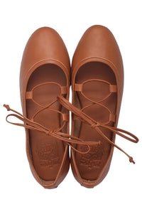 A pair of brown leather ballet flats with lace-up front straps, shown from a top-down view on a white background.