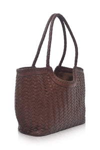 Brown woven handbag on a white background