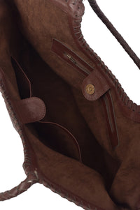 Close-up of a brown leather bag with visible stitching and texture.