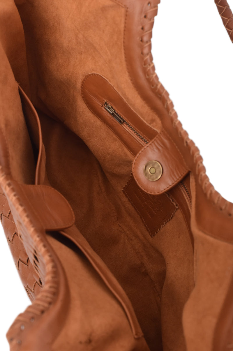 Close-up of a brown leather bag with stitching details