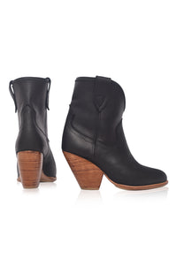 Black ankle boots with wooden soles on a white background