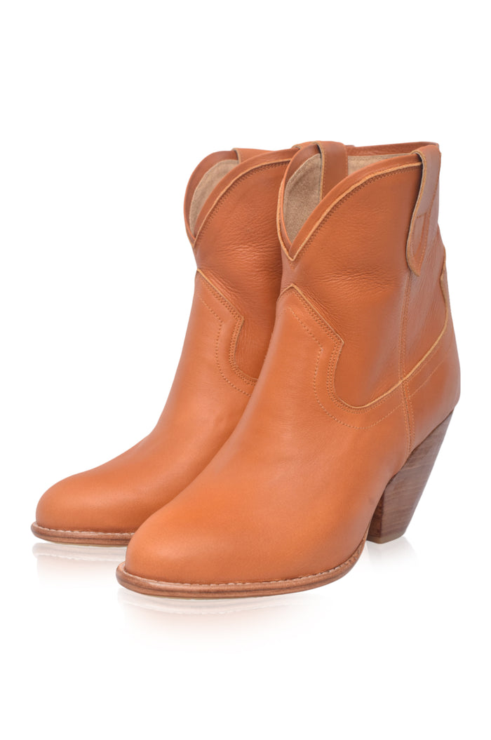 Pair of tan leather ankle boots on a white background