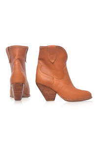 Pair of brown leather ankle boots on a white background