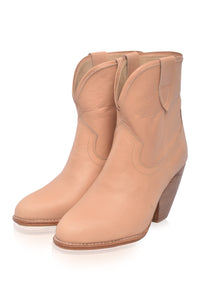 Pair of tan cowboy boots on a white background