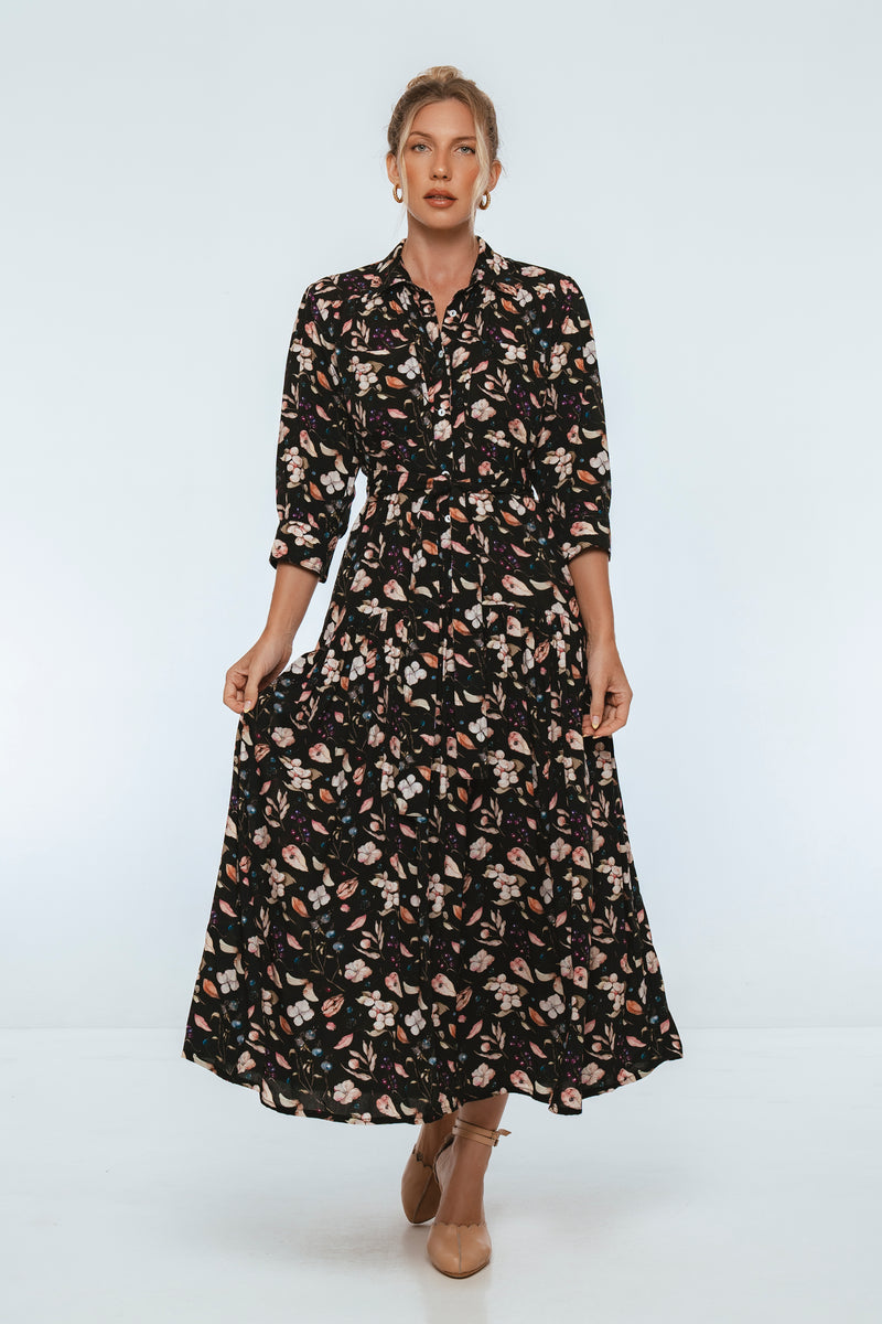 Woman wearing a black floral dress on a white background