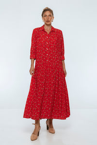 Woman wearing a red dress with a pattern on a white background