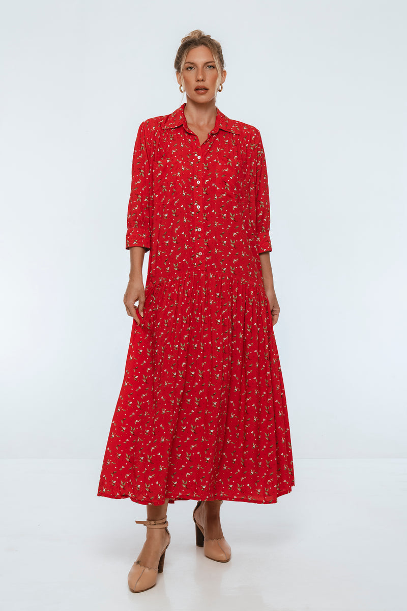 Woman wearing a red dress with a pattern on a white background