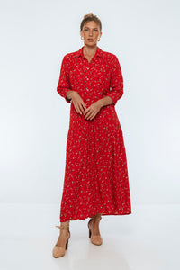 Woman wearing a red dress with a white pattern on a white background
