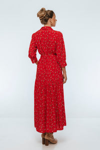 Woman wearing a red floral dress on a white background