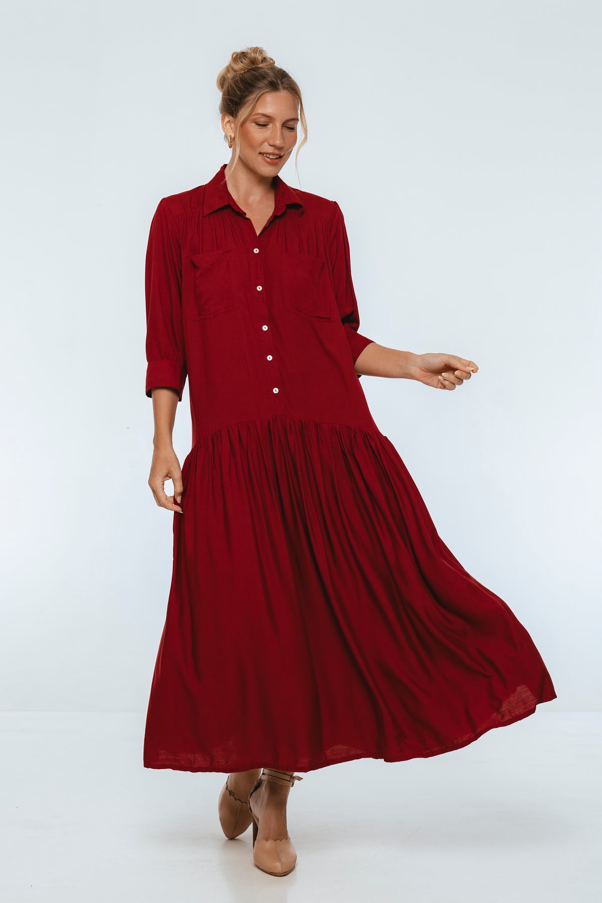Woman wearing a red dress on a white background