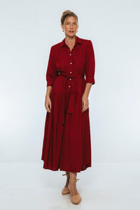 Woman wearing a burgundy dress on a white background