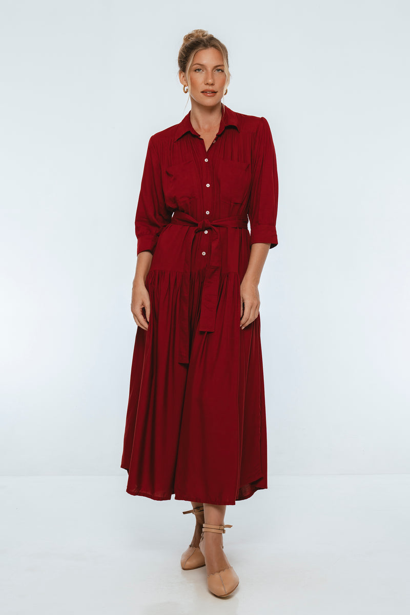 Woman wearing a burgundy dress on a white background