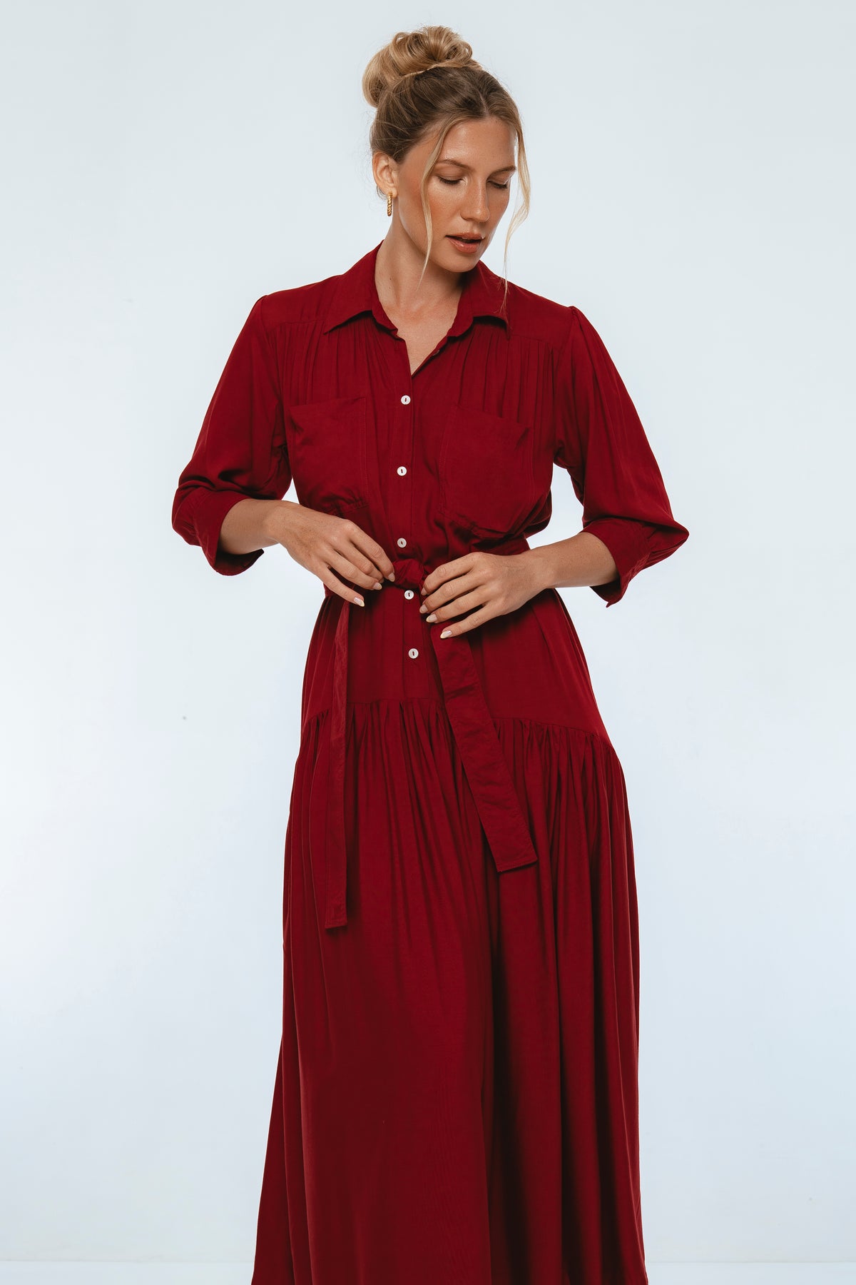 Woman wearing a red dress against a white background