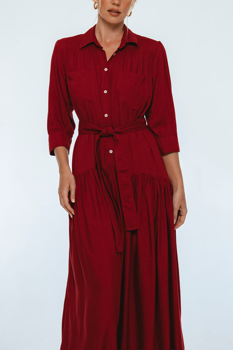 Red dress worn by a model on a white background