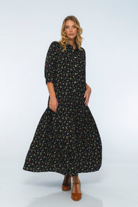 Woman wearing a black floral dress on a white background