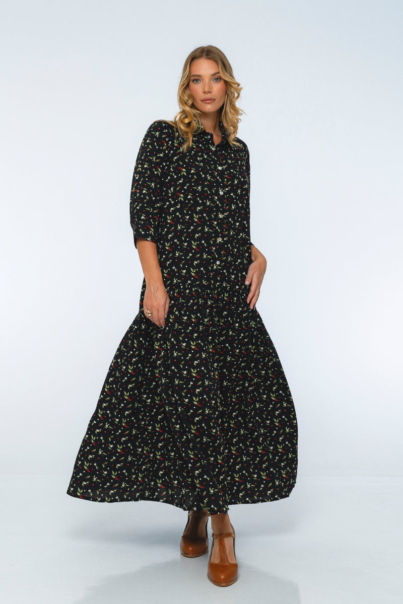 Woman wearing a black floral dress on a white background
