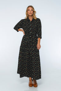 Woman wearing a black floral dress on a white background