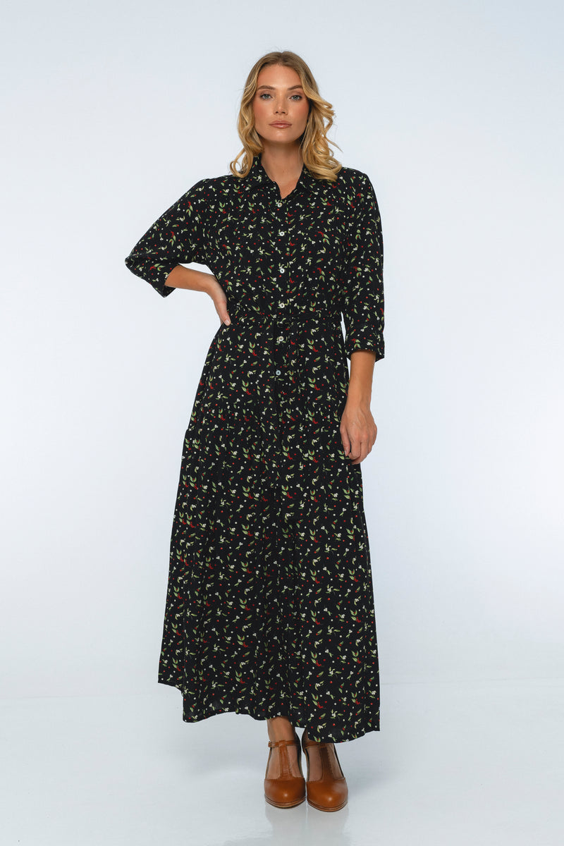 Woman wearing a black floral dress on a white background