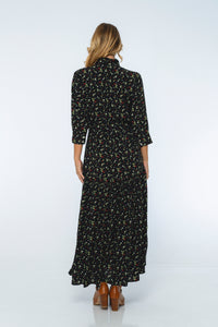 Woman wearing a black floral dress on a white background