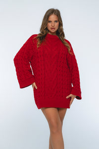 Woman wearing a red cable knit sweater dress on a white background