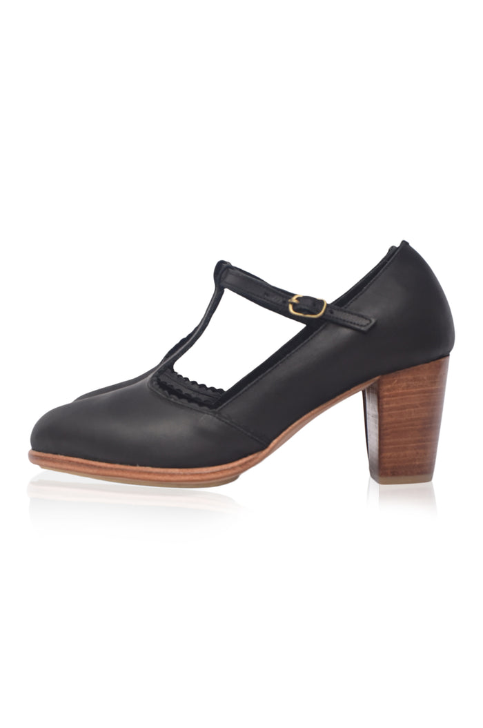 Black shoe with wooden heel on a white background