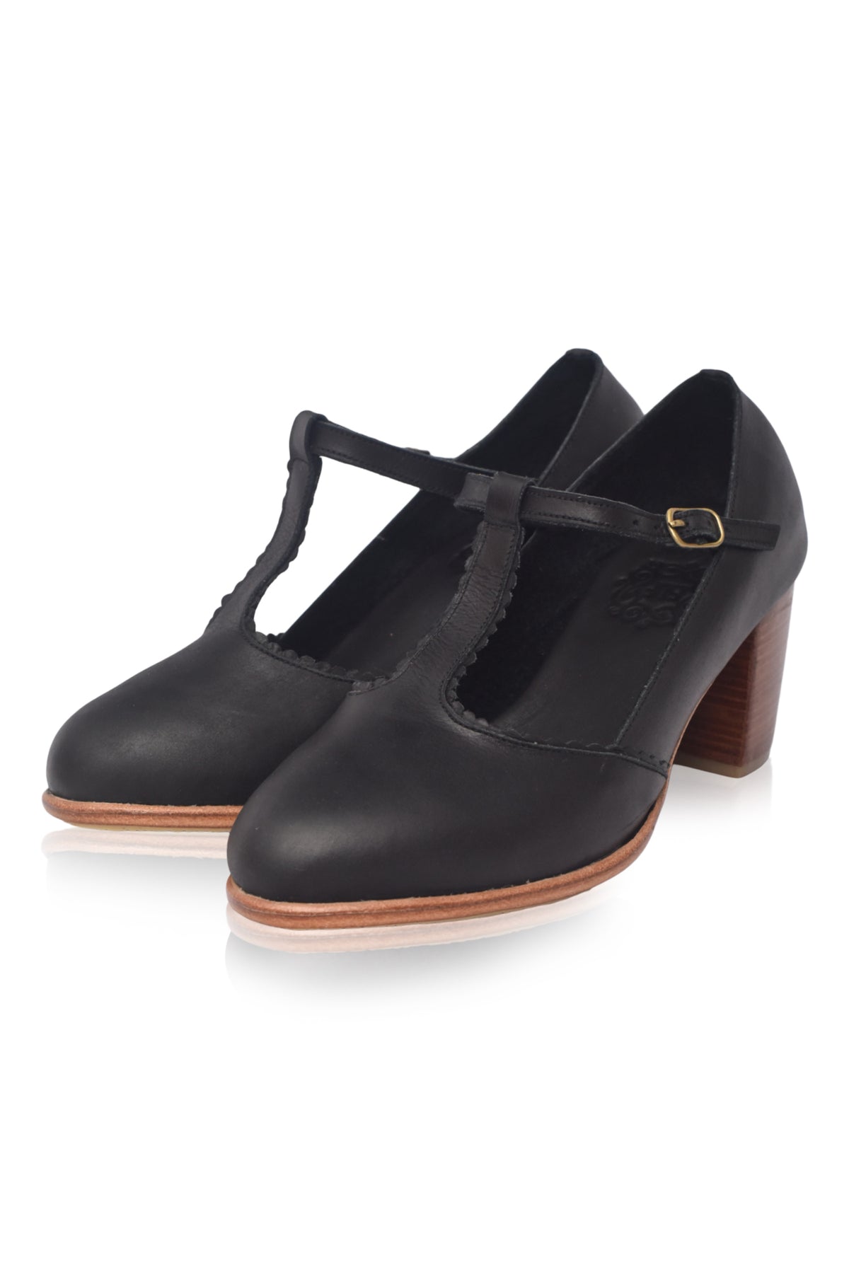 Black leather shoes with a T-strap design on a white background