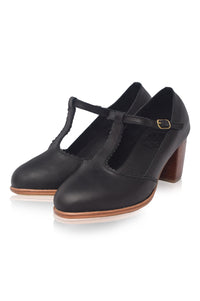 Black leather shoes with a T-strap design on a white background