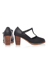 Black high-heeled shoes with wooden soles on a white background