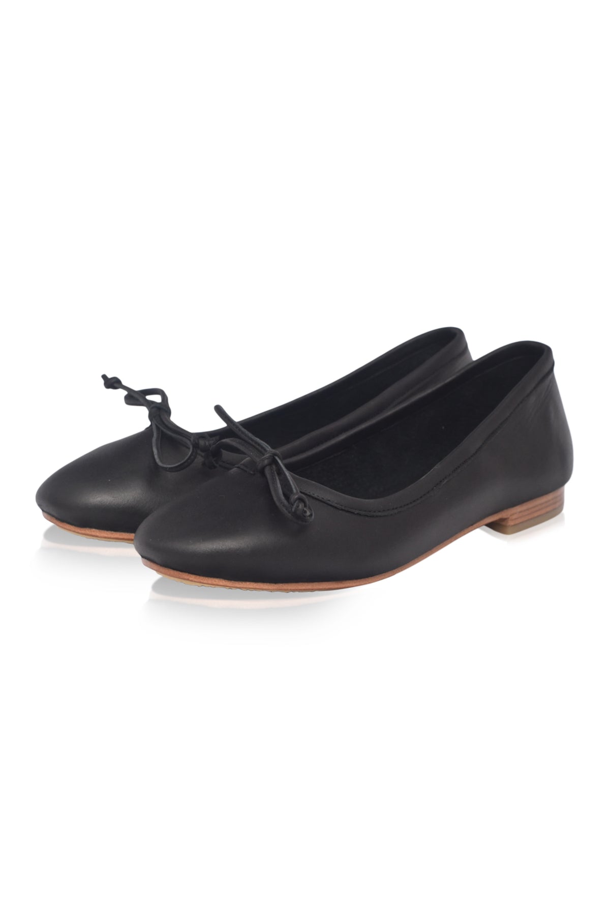 Pair of black leather shoes with a bow on a white background