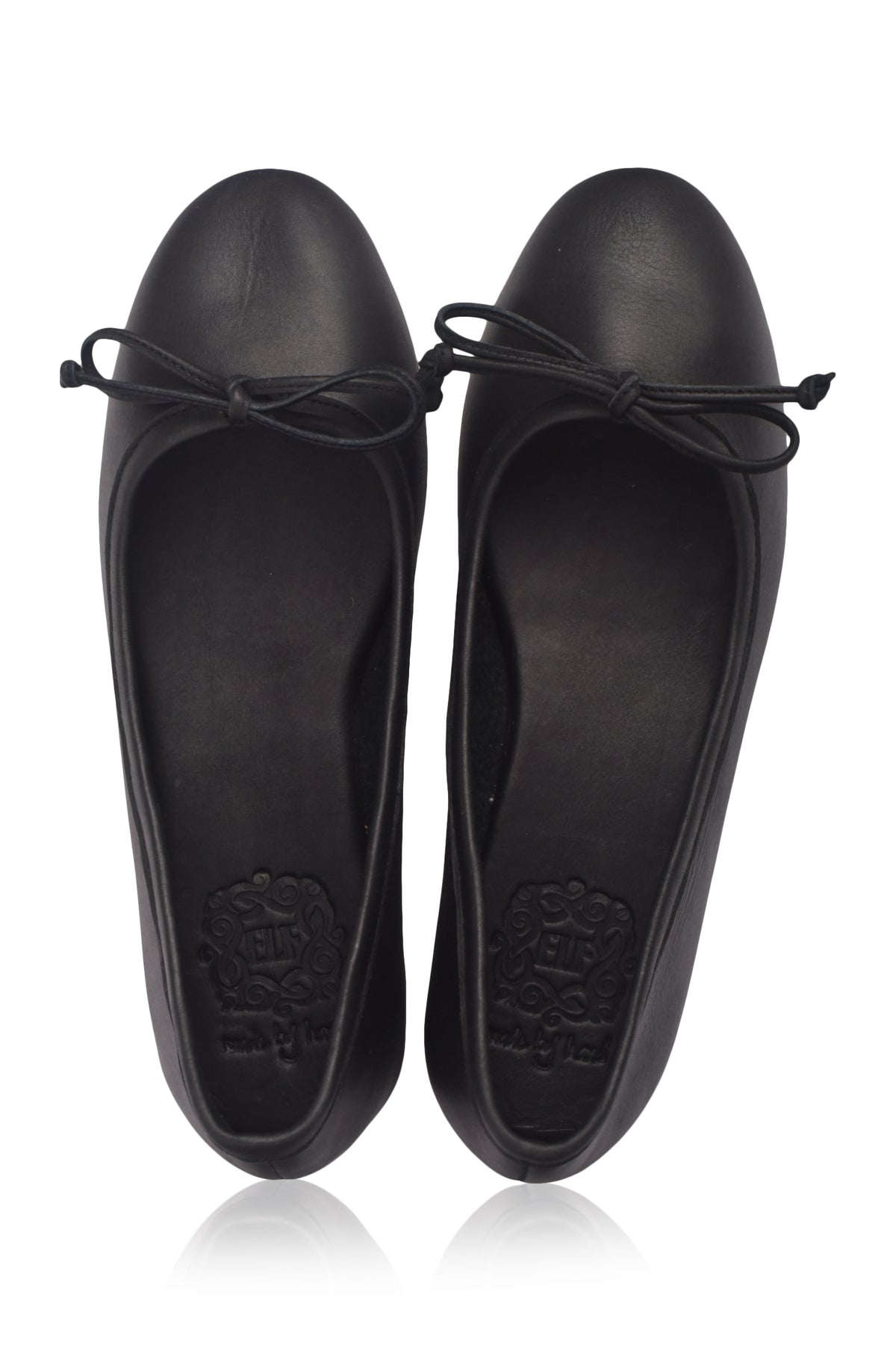 Pair of black flat shoes with bow details on a white background