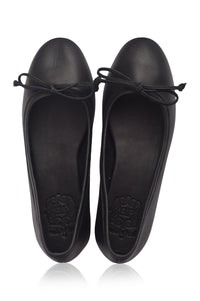 Pair of black flat shoes with bow details on a white background