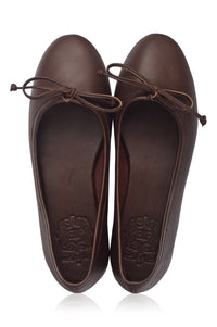 Pair of brown leather flats with bow details on a white background