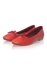 Red ballet flats with a bow on a white background
