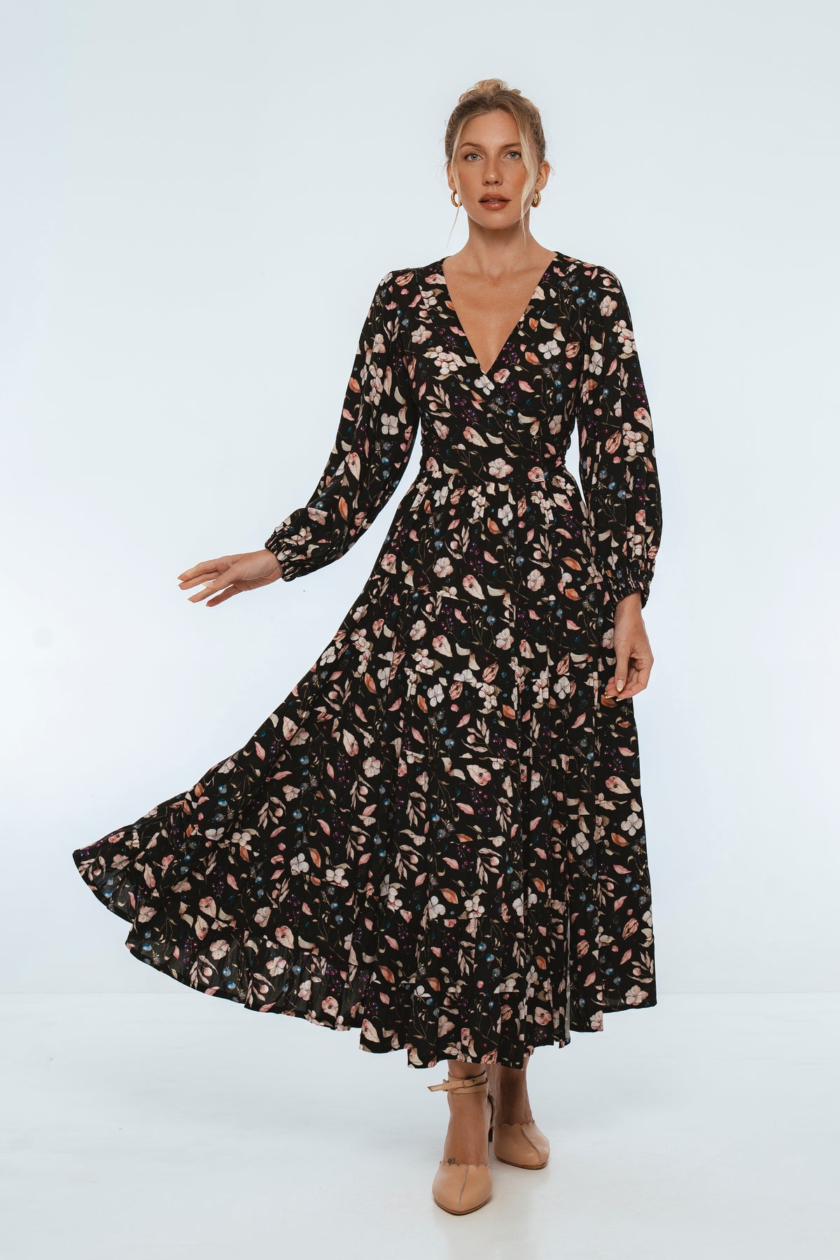 Woman wearing a black floral dress on a white background
