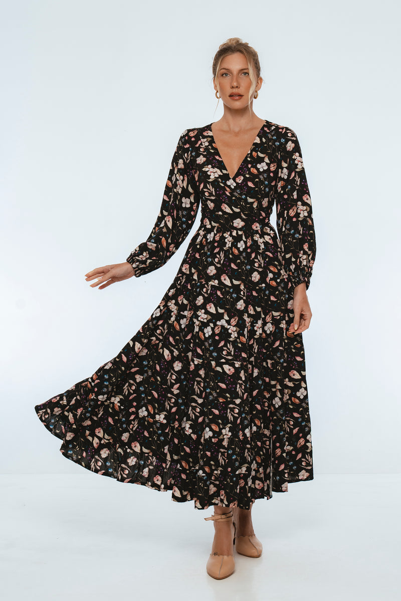 Woman wearing a black floral dress on a white background