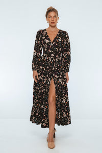 Woman wearing a black floral dress on a white background