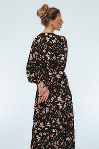 Woman wearing a floral dress against a white background