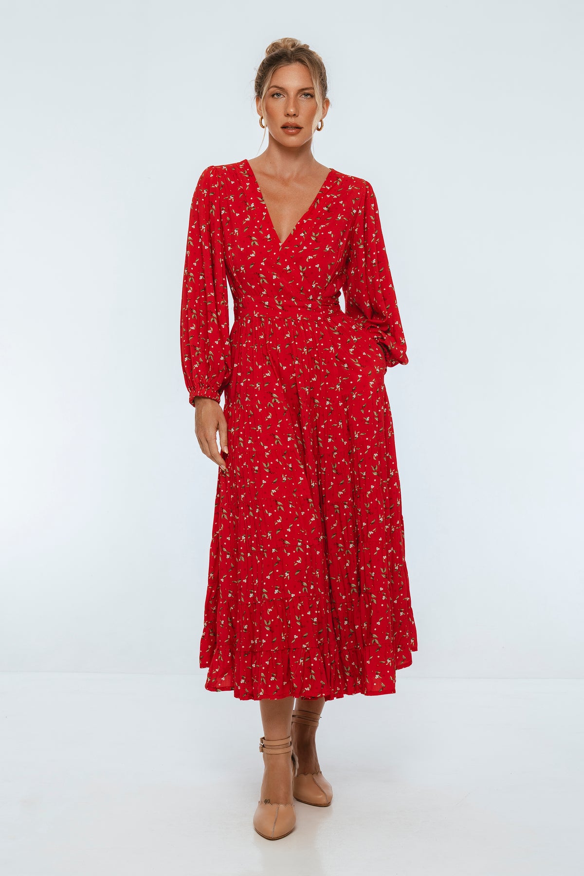 Woman wearing a red dress with a white background