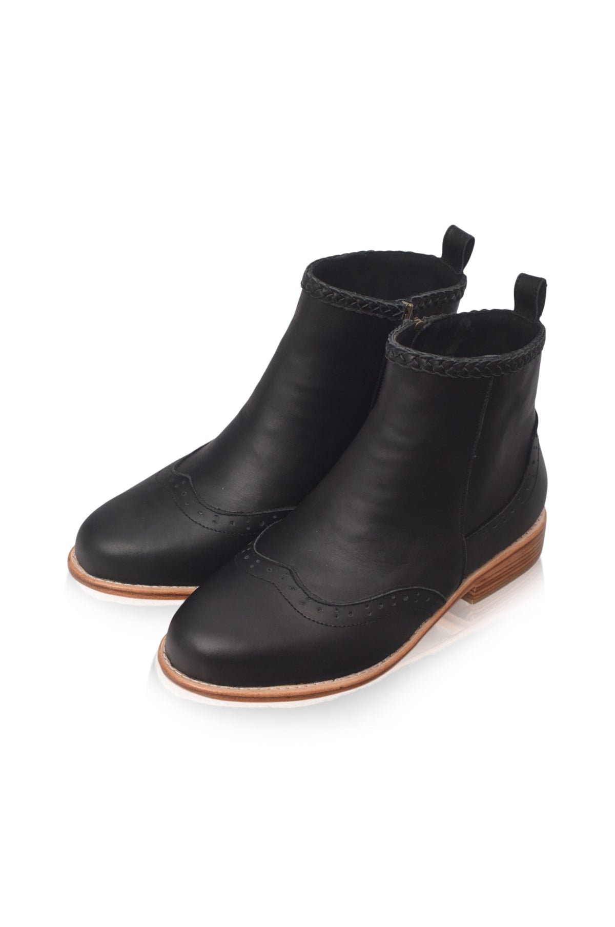 A pair of black leather ankle boots with a low brown sole, shown from a three-quarters angle on a white background.