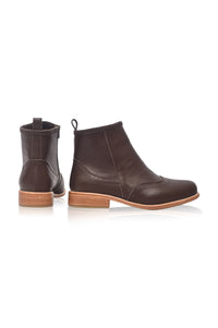 A pair of dark brown leather ankle boots with low stacked heels, shown from the side and back on a white background.