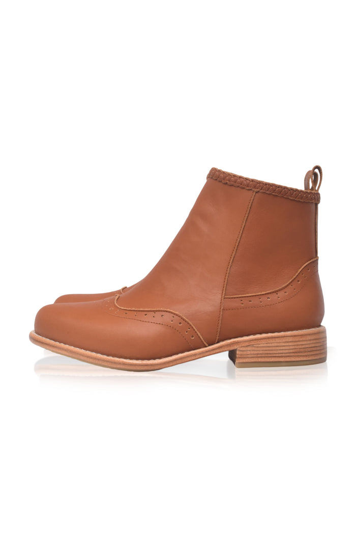 A single brown leather ankle boot with a low stacked heel and pull tab, shown in a side profile on a white background.